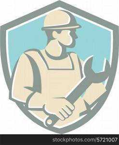 Illustration of a construction worker wearing hat holding spanner looking to the side set inside shield crest on isolated background done in cartoon style. . Construction Worker Spanner Shield Cartoon