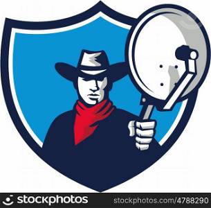 Illustration of a cowboy holding aiming satellite dish viewed from front set inside shield crest on isolated background done in retro style. . Cowboy Aiming Satellite Dish Crest Retro