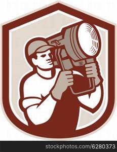Illustration of a electrical lighting technician crew carry fresnel spotlight on shoulder looking to side set inside shield crest shape on isolated background done in retro style.. Electrical Lighting Technician Carry Spotlight Shield