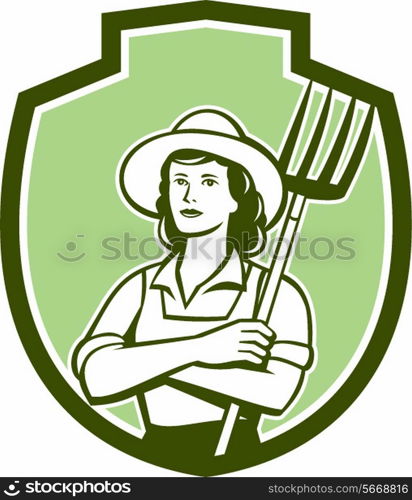 Illustration of a female organic farmer with pitchfork with hat facing front set inside shield crest on isolated bakcground done in retro style.