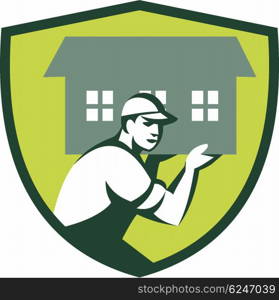 Illustration of a house remover carrying house on shoulder viewed from the side set inside shield crest` done in retro style.