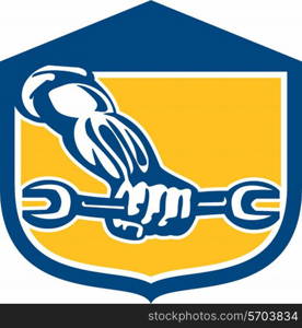 Illustration of a mechanic hand holding spanner wrench set inside shield crest on isolated background done in retro style.. Mechanic Hand Holding Spanner Shield Retro