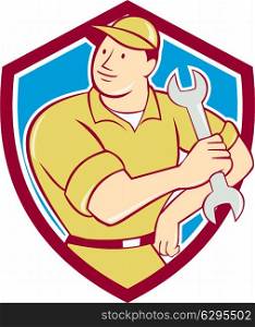 Illustration of a mechanic holding spanner wrench looking to the side with hand on hip set inside shield crest on isolated background done in cartoon style.. Mechanic Hold Spanner Wrench Shield Cartoon