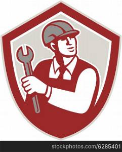 Illustration of a mechanic wearing hardhat holding spanner wrench lookiong up facing front set inside crest shield on isolated background done in retro style.. Mechanic Holding Wrench Shield Crest Retro