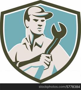 Illustration of a mechanic wearing hat holding spanner wrench facing front inside shield crest on isolated background done in retro style.. Mechanic Holding Spanner Front Shield Retro