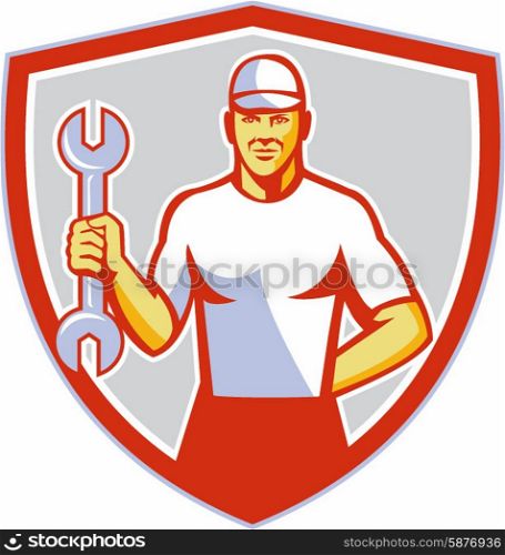 Illustration of a mechanic wearing hat holding wrench facing front set inside shield crest on isolated background done in retro style. . Mechanic Holding Wrench Crest Retro