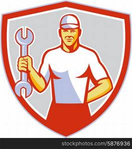 Illustration of a mechanic wearing hat holding wrench facing front set inside shield crest on isolated background done in retro style. . Mechanic Holding Wrench Crest Retro