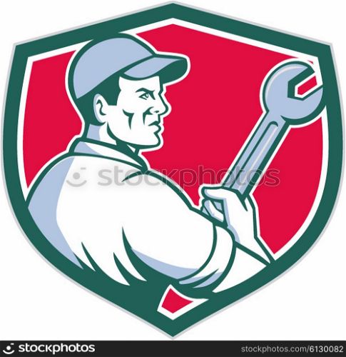Illustration of a mechanic worker holding monkey wrench viewed from the side set inside shield crest on isolated background done in retro style. . Mechanic Holding Monkey Wrench Shield Retro