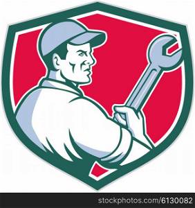 Illustration of a mechanic worker holding monkey wrench viewed from the side set inside shield crest on isolated background done in retro style. . Mechanic Holding Monkey Wrench Shield Retro