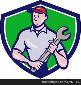 Illustration of a mechanic worker standing looking to the side carrying spanner viewed from front set inside shield crest on isolated background done in cartoon style. . Mechanic Worker Standing Spanner Crest Cartoon