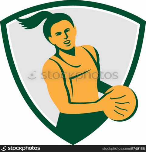 Illustration of a netball player holding ball viewed from front set inside shield crest on isolated white background done in retro style. . Netball Player Holding Ball Retro