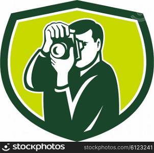 Illustration of a photographer shooting with dslr digital camera set inside shield crest done in retro style.. Photographer Shooting DSLR Camera Crest Retro