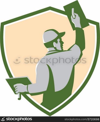Illustration of a plasterer masonry tradesman construction worker with trowel viewed from the back set inside shield crest done in retro style on isolated background. Plasterer Masonry Trowel Shield Retro
