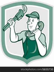Illustration of a plumber holding monkey wrench and telephone talking set inside shield crest done in cartoon style on isolated background.. Plumber Monkey Wrench Telephone Shield Cartoon