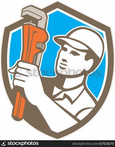 Illustration of a plumber holding monkey wrench looking to the side set inside shield crest on isolated background done in retro style. . Plumber Holding Wrench Shield Retro