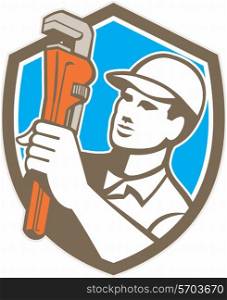 Illustration of a plumber holding monkey wrench looking to the side set inside shield crest on isolated background done in retro style. . Plumber Holding Wrench Shield Retro