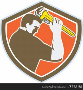 Illustration of a plumber holding monkey wrench viewed from the side set inside crest shield on isolated background done in retro style. . Plumber Holding Monkey Wrench Crest Retro