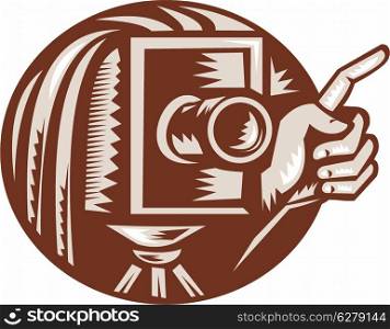 Illustration of a vintage bellow camera with hand pointing done in retro woodcut style set inside circle.. Vintage Camera Hand Pointing Retro Woodcut