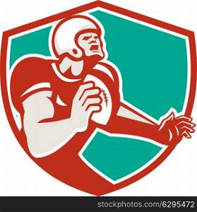 Illustration of an angry american football player holding ball looking up set inside shield crest on isolated background done in retro style. . American Football Player Angry Shield Retro