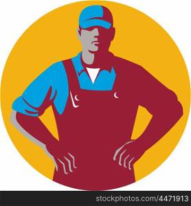 Illustration of an organic farmer wearing hat and overalls with hands on hips akimbo facing front set inside circle on isolated background done in retro style.