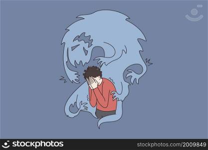 Inner fears and danger concept. Frustrated stressed boy standing covering face with hands and feeling afraid of ghost flying around vector illustration . Inner fears and danger concept.
