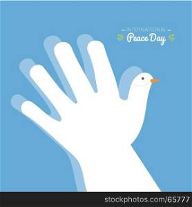 International peace day with hand making the shape of a dove on a blue sky background