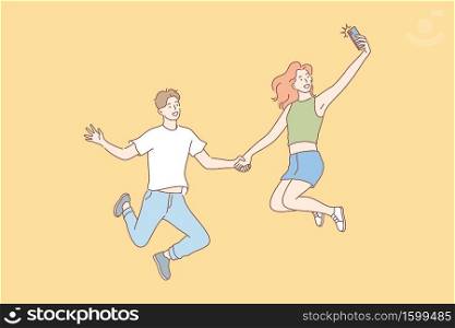 Jumping people, selfie, couple, leisure concept. Jumping people, man and woman, boyfriend girlfriend or teenagers, couple in love, taking selfie on smartphone for social media. Modern lifestyle.. Jumping people, selfie, couple, leisure concept