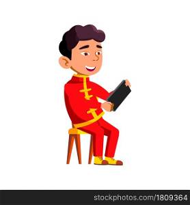 Kid Boy Using Smartphone Digital Gadget Vector. Asian Child Sitting On Chair And Playing Video Game On Smartphone. Japanese Character Playing Phone Application Flat Cartoon Illustration. Kid Boy Using Smartphone Digital Gadget Vector