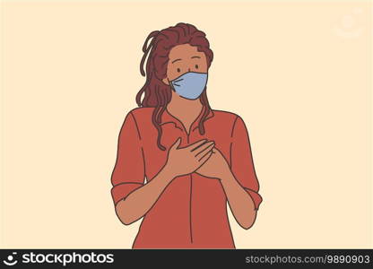 Kindness and support during COVID-19 epidemic concept. Portrait of kind black woman in respiratory mask from coronavirus infection holding hands on chest as symbol of love and care . Kindness and support during COVID-19 epidemic concept