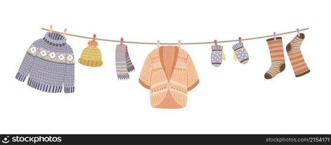 Knitted clothes on rope. Knit, wool thread cardigan and sweater. Knitting accessories, mittens and warm socks vector banner. Illustration of textile clothes, cotton clothing knit. Knitted clothes on rope. Knit, wool thread cardigan and sweater. Knitting accessories, mittens and warm socks vector banner