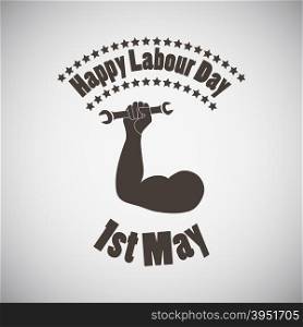 Labour day emblem with biceps and wrench in fist. Vector illustration.