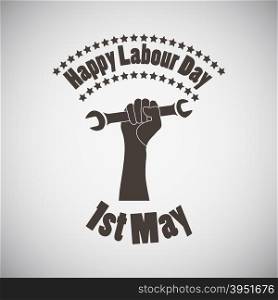 Labour day emblem with wrench in fist. Vector illustration.