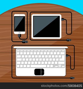 Laptop, digital tablet, smartphone with usb cables ready for connection and work on wood table flat design