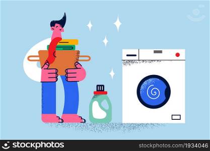 Laundry service and housework concept. Young smiling man cartoon character standing holding basket with dirty clothes near washing machine for making laundry vector illustration . Laundry service and housework concept