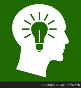 Light bulb inside head icon white isolated on green background. Vector illustration. Light bulb inside head icon green