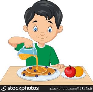 Little boy flowing maple syrup on pancakes with blueberries