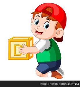 little boy holding the alphabet cube
