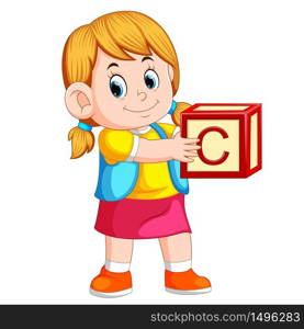 little girl holding the alphabet cube