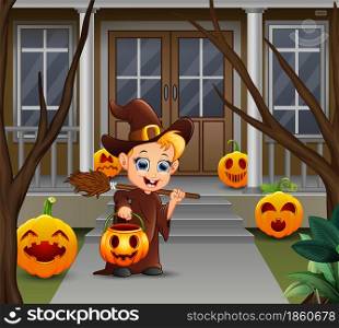 Little witch holding pumpkin basket standing in front of the house
