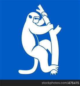 Macaque on a tree icon white isolated on blue background vector illustration. Macaque on a tree icon white