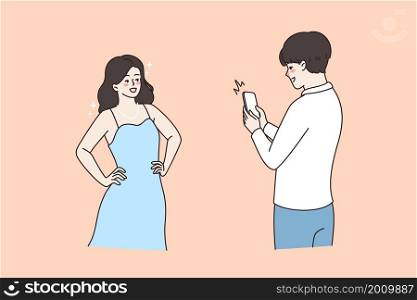 Making photo and camera concept. Young smiling man standing and making photo of his pretty girlfriend on smartphone having fun vector illustration . Making photo and camera concept.