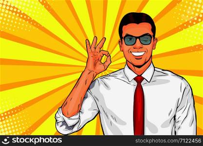 Male businessman in glasses winks and shows okay or OK gesture. Pop art retro vector illustration. Success concept. Invitation poster.