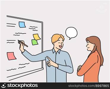Man and woman employees of startup stand at whiteboard are brainstorming to solve business problems. Colleagues together looking for way to increase company revenue by brainstorming. Man and woman employees of startup stand at whiteboard are brainstorming