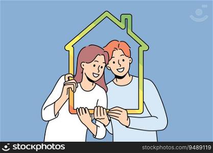 Man and woman with house outline symbolizing family property and sustainable energy efficient housing. Young couple recommends taking out mortgage or insuring house to avoid possible problems. Man and woman with house outline symbolizing family property and energy efficient housing