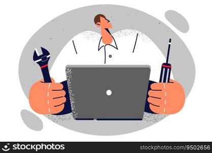 Man computer technician holding screwdriver and wrench sitting at table with laptop. Guy works as system administrator wants to fix computer or upgrade motherboard to increase speed of work. Man computer technician holding screwdriver and wrench sitting at table with laptop.