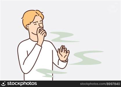 Man covers nose so as not to smell unpleasant smell from harmful production that pollutes environment. Guy grimaces and closes eyes, feels vile stench coming from missing products or garbage dump. Man covers nose so as not to smell unpleasant smell from harmful production 