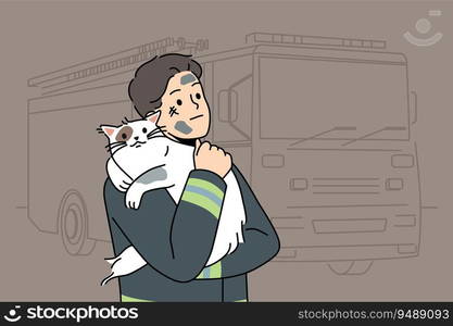 Man firefighter with cat heroically rescued from burning house stands near fire truck and hugs pet. Brave guy in uniform of firefighter or rescue worker helped cat get out of trouble. Man firefighter with cat heroically rescued from burning house stands near fire truck and hugs pet