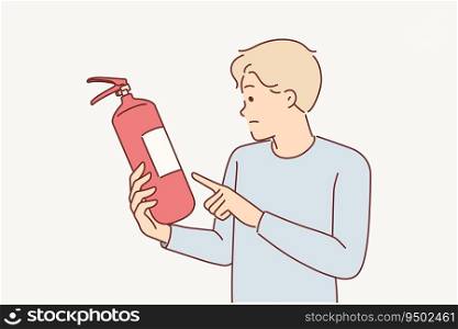 Man holds fire extinguisher checking expiration date of equipment for extinguishing flame in emergency. Guy controls quality of fire extinguisher, for concept of preventive measures to combat burning. Man holds fire extinguisher checking expiration date equipment for extinguishing flame in emergency