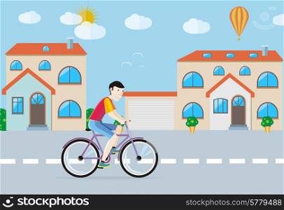 Man in red T-shirt riding his bike on the road among buildings in town