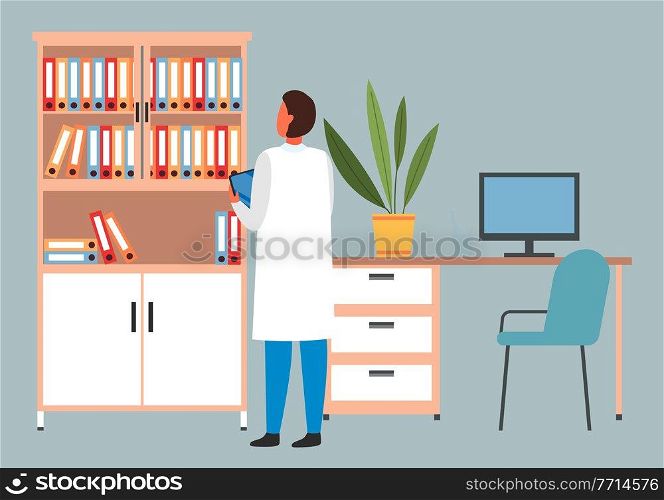 Man is standing with a clipboard or tablet. Male doctor looking at the bookcase with documents. Hospital worker spends time in the medical institution. The doctor works with paper and documentation. Man is standing with a clipboard or tablet. Male doctor looking at the bookcase with documents